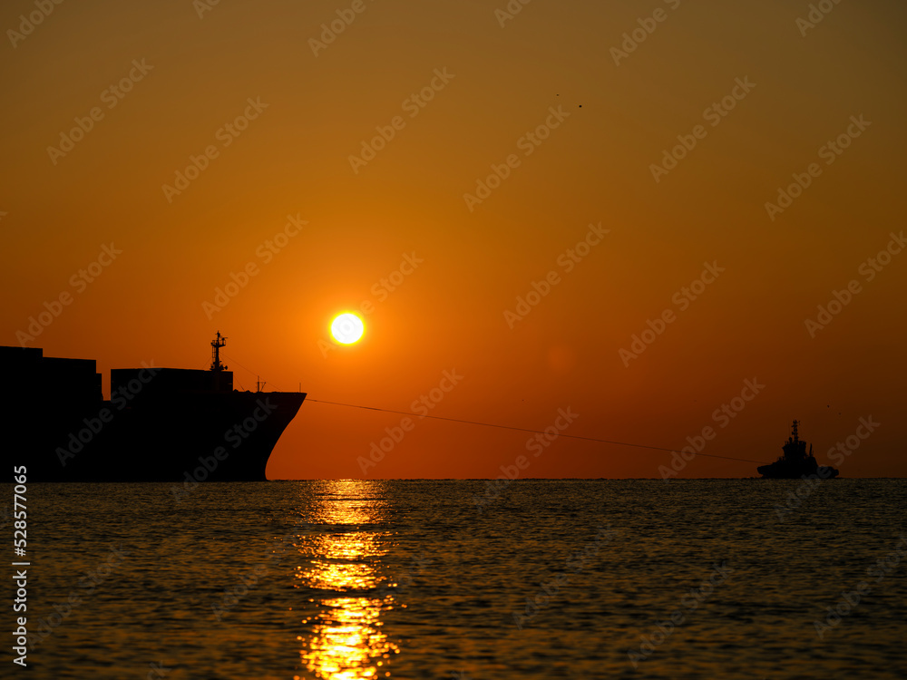 a ship leaving port at sunrise