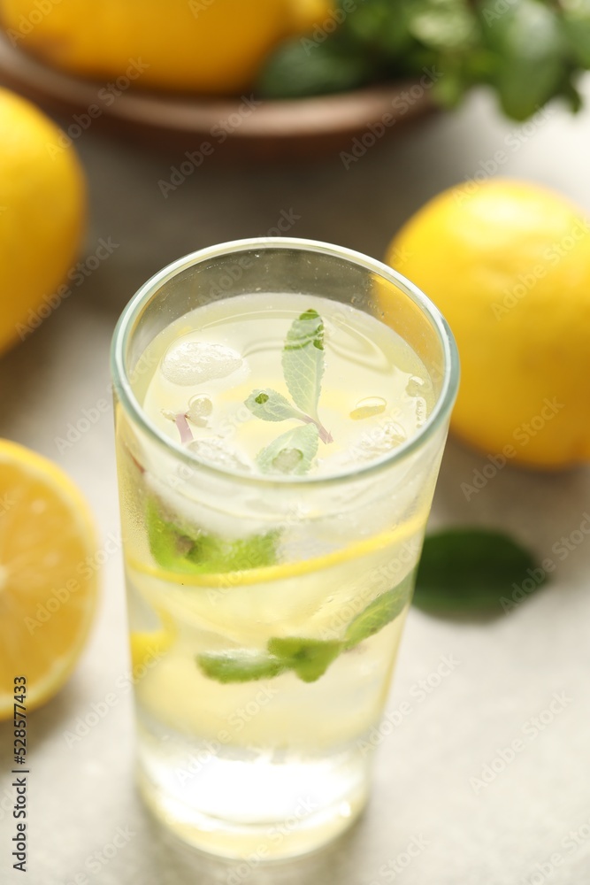 Cool freshly made lemonade in glass on light table, closeup Cool freshly made lemonade in glass on light table, closeup
