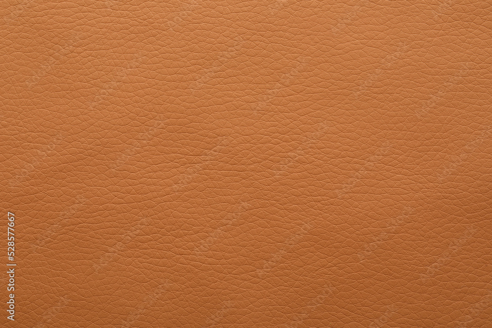 Fototapeta premium Texture of orange leather as background, closeup
