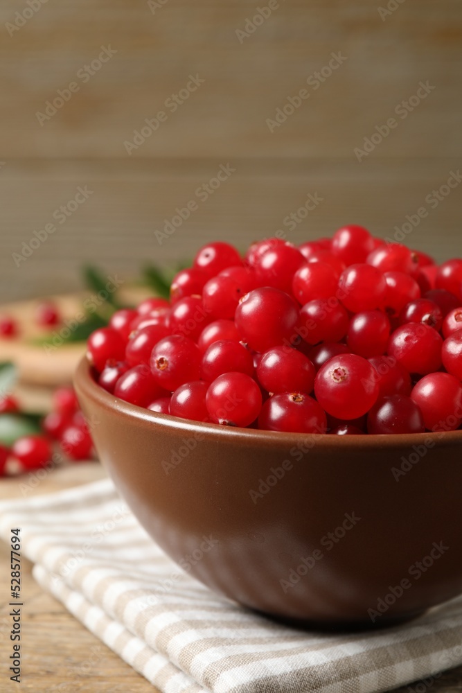 Tasty ripe cranberries on wooden table, closeup Tasty ripe cranberries on wooden table, closeup