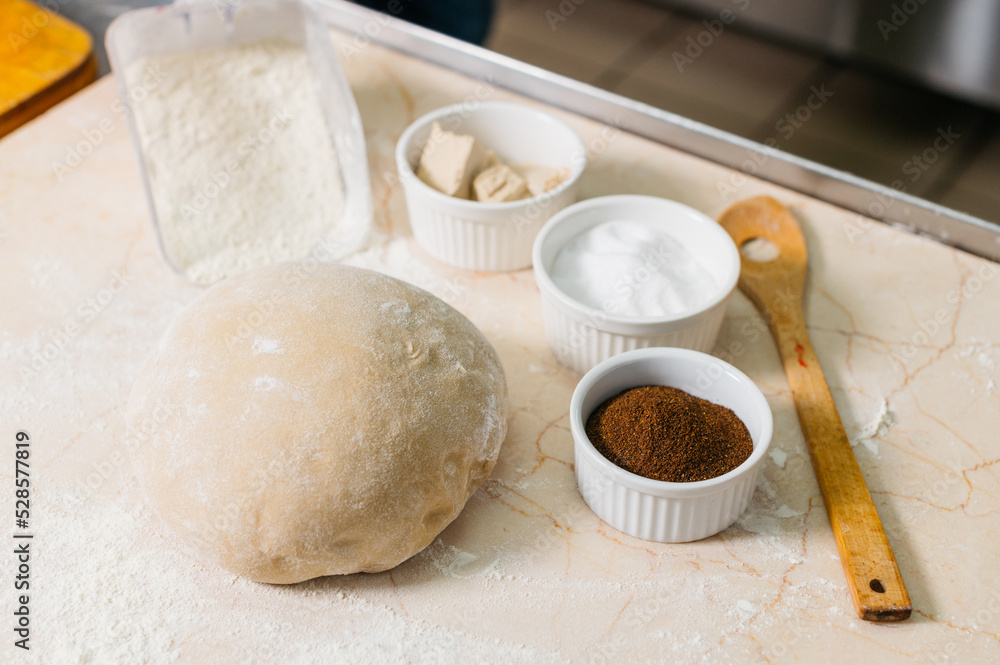Fototapeta premium Ready-made dough for baking bread on the table