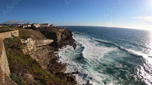 Ocean waves crashing on the high cliffs in Azenhas do Mar, Portugal photo