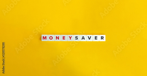 Money Saver Phrase on Block Letter Tiles on Yellow Background. Minimal Aesthetics. photo