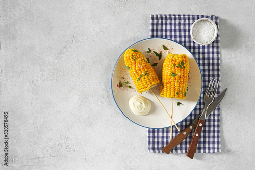 Plate with tasty Corn on white background, ctop view, copy space photo