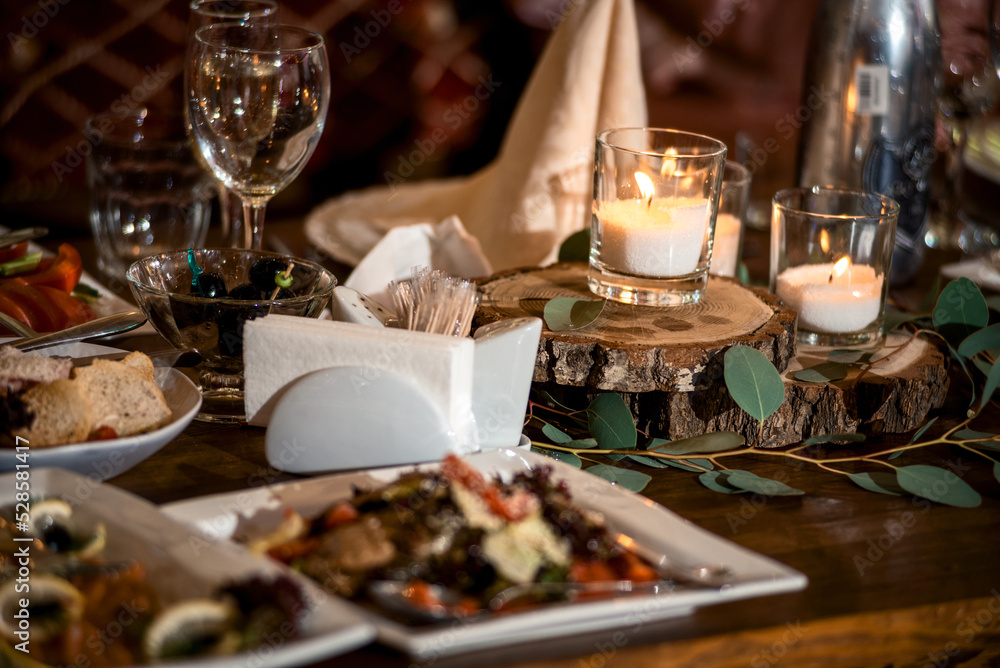 festive food on the table and candles in glasses. romantic setting