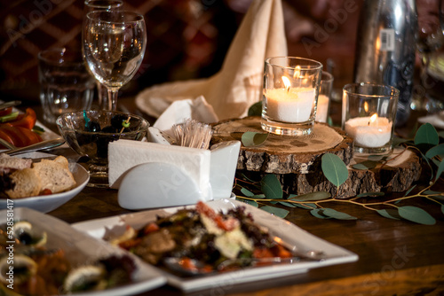 festive food on the table and candles in glasses. romantic setting © Алексей Еремеев