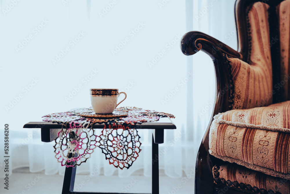 turkish coffee and lace doily under coffee, vintage style armchair wooden, curtain behind them near window - obrazy, fototapety, plakaty 