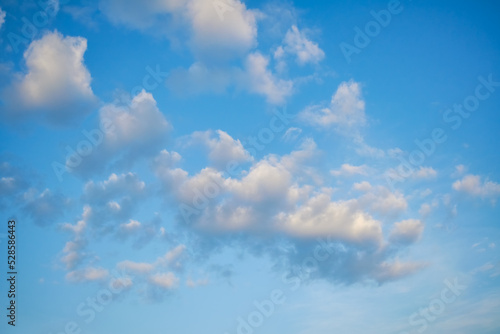 White fluffy clouds in the blue sky. Blue summer sky with white cumulus clouds.
