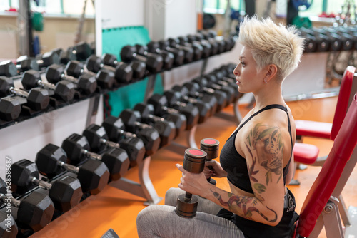 A young woman is engaged in fitness at the GYM. © Aleksandr Rybalko