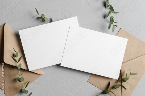 Billede på lærred Wedding invitation card mockup with envelopes and eucalyptus, front and back sid