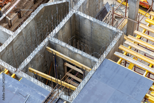 Cast-in-place concrete. Construction of monolithic walls. Formwork, scaffolding and reinforcing bars at the construction site. High-rise construction