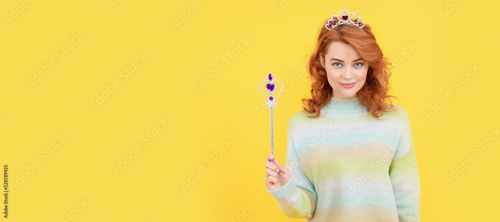 smiling redhead woman in queen crown with magic wand, wish. Woman isolated face portrait, banner with copy space. smiling redhead woman in queen crown with magic wand, wish. Woman isolated face portrait, banner with copy space.