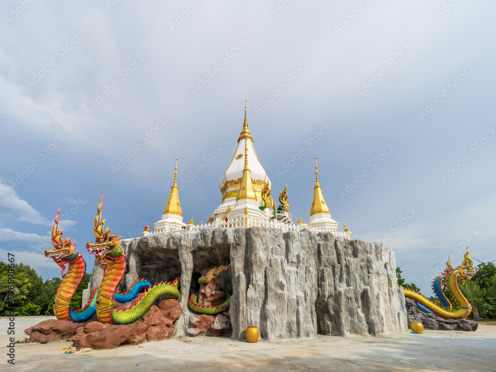 Naklejka premium Mukdahan, Thailand - July 31, 2022: Two Nagas at the entrance of the pagoda at Wat Dan Phra In, Nikhom Kham Soi, Mukdahan, Thailand