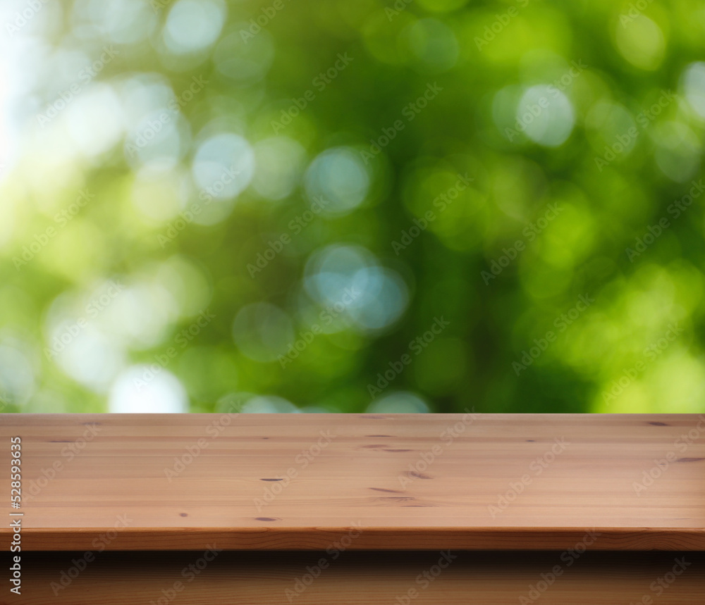 Empty wooden surface against blurred green background. Space for design Empty wooden surface against blurred green background. Space for design