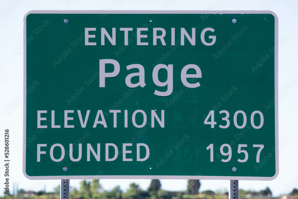 Green metal road sign Entering Page, Arizona showing elevation and date founded Green metal road sign Entering Page, Arizona showing elevation and date founded