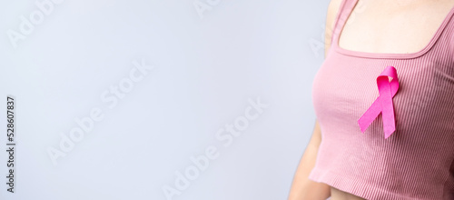 Fotografie, Tablou Pink October Breast Cancer Awareness month, woman hand hold pink Ribbon and wear shirt for support people life and illness