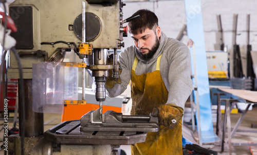 Craftsman working on drilling machine