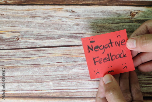 Obraz na płótnie How to handle customer negative feedback concept. Hand holding red note with written word with copy space. w salonie