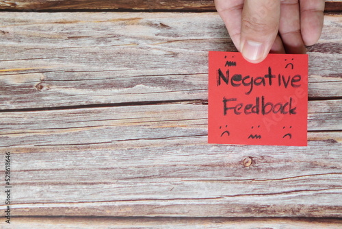 How to handle customer negative feedback concept. Hand holding red note with written word with copy space.