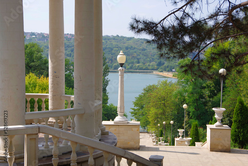 Moldova. Kishinev. 08.28.2022. Arbor with white columns and a view of the lake. Park Valea Morilor.