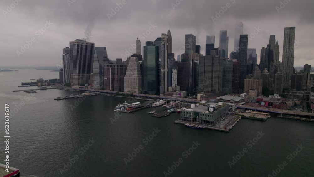 Aerial view on Brooklyn bridge on overcast weather in New York, Manhattan. Hudson river of New York. Attraction of New York most popular bridge in the USA. Famous place for tourists in the World. Aerial view on Brooklyn bridge on overcast weather in New York, Manhattan. Hudson river of New York. Attraction of New York most popular bridge in the USA. Famous place for tourists in the World.