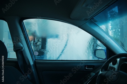Man washing car. View from inside car © Vedrana