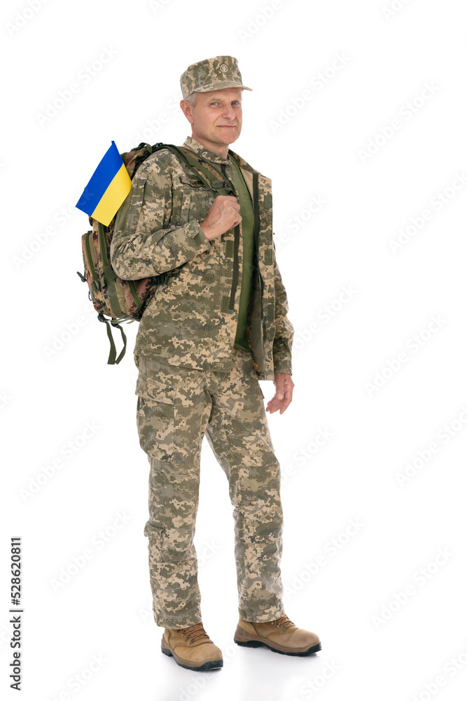 Ukraine army soldier isolated on white background. Full length portrait of old defende with backpack and Ukrainian flag. Stand for Ukraine. Ukraine army soldier isolated on white background. Full length portrait of old defende with backpack and Ukrainian flag. Stand for Ukraine.
