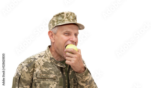 Tableau sur toile Soldier eat green apple and smiling to the camera