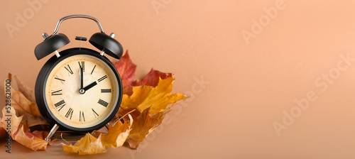 Alarm clock and autumn leav...