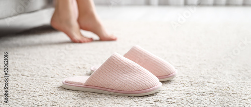 Soft comfortable slippers on carpet photo