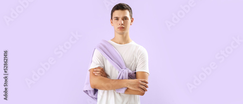 Teenage boy in t-shirt on lilac background