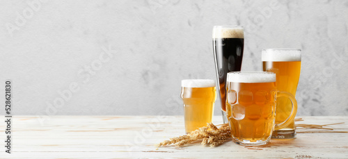 Vászonkép Glassware with fresh beer on light background with space for text