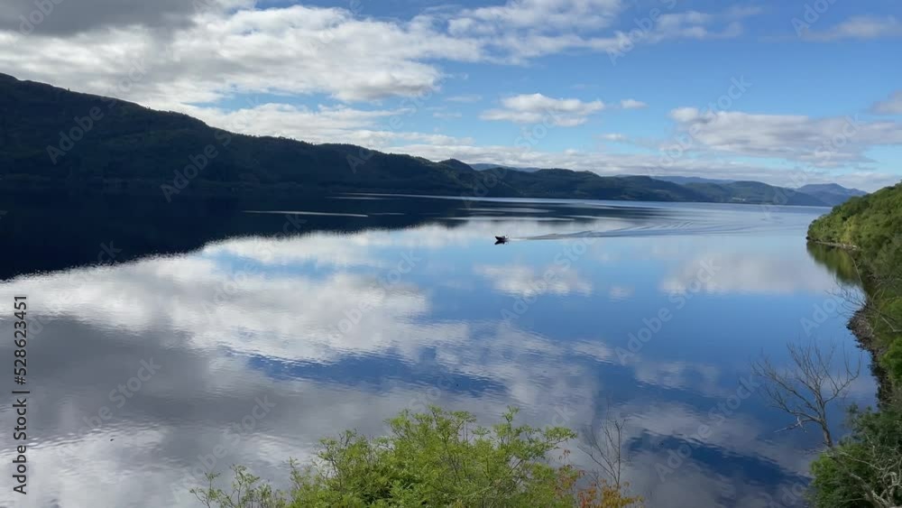 Tracking Shot Of A Small Singular Fishing Vessel Sailing On Loch Ness Tracking Shot Of A Small Singular Fishing Vessel Sailing On Loch Ness