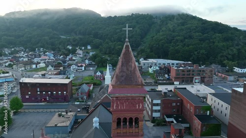 Church steeple. Aerial orbit, establishing shot of Johnstown Pennsylvania. Rural city in decline. photo