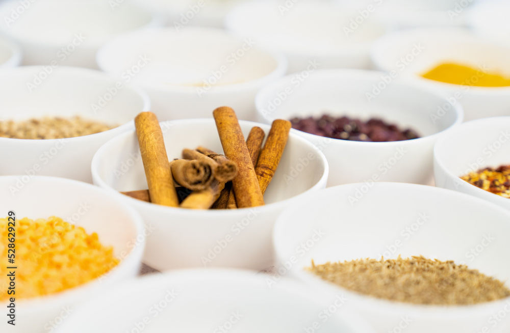 Cinnamon sticks in a bowl amongst spices Cinnamon sticks in a bowl amongst spices