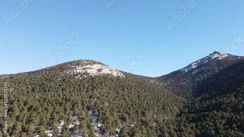 Snowy mountain range against clear blue sky in Fuenfria Valley, Cercedilla (Madrid) photo
