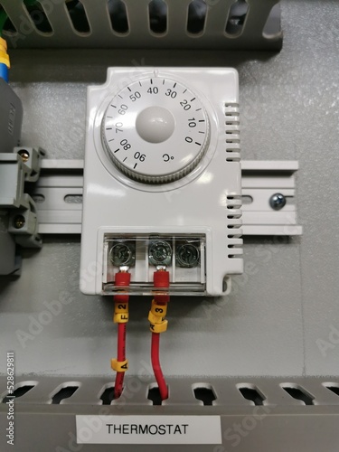 Photo of thermostat regulator in electrical cabinet. photo