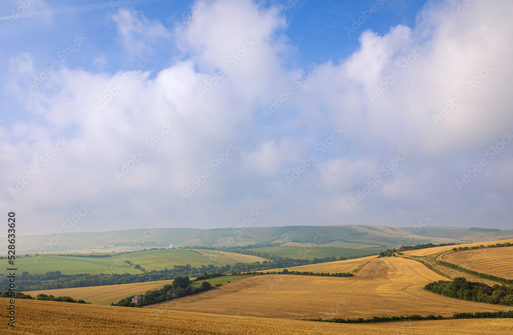 View of Kingston ridge from Lewes downs with September morning mist clearing east Sussex south east England