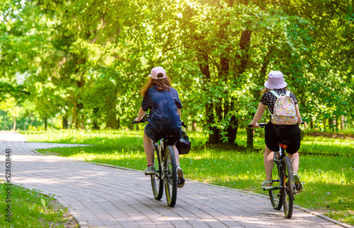Wallpaper Mural Cyclists ride on the bike path in the city Park
 Torontodigital.ca