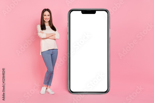 Photo of marketer lady presenting offer large big telephone touchscreen panel new design device isolated pink color background