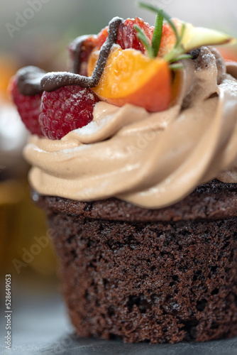 Chocolate cupcakes with fruits. A beautiful dessert. High quality photo
