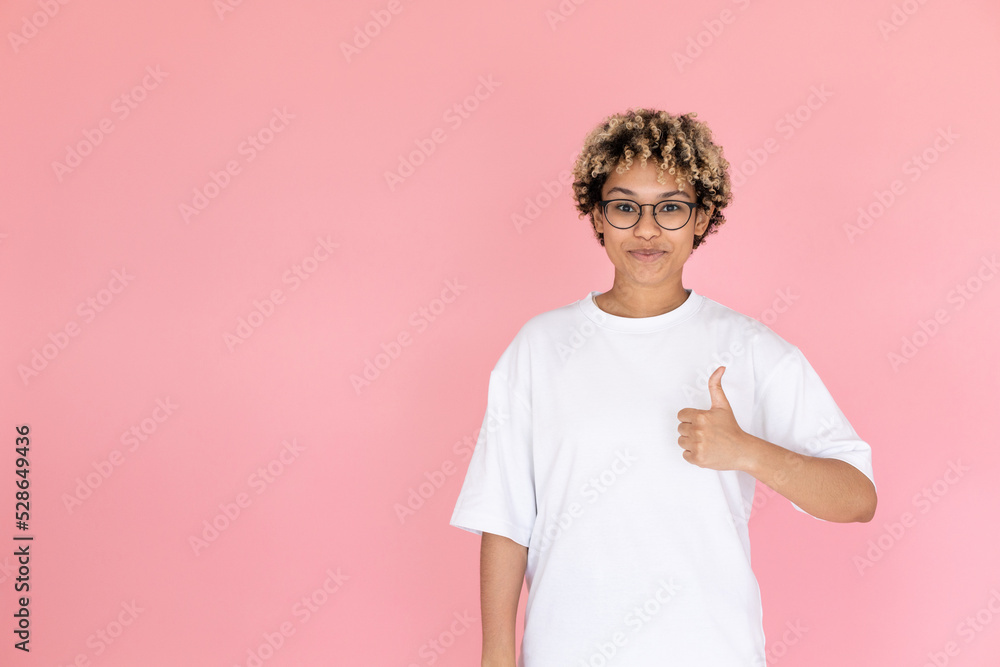 Portrait of pleased African American woman. Female model in glasses with curly hair looking at camera, gesturing. Portrait, studio shot, emotion concept Portrait of pleased African American woman. Female model in glasses with curly hair looking at camera, gesturing. Portrait, studio shot, emotion concept