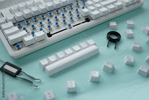 Concept of cleaning disassembled mechanical keyboard game with switch puller and keycaps puller.