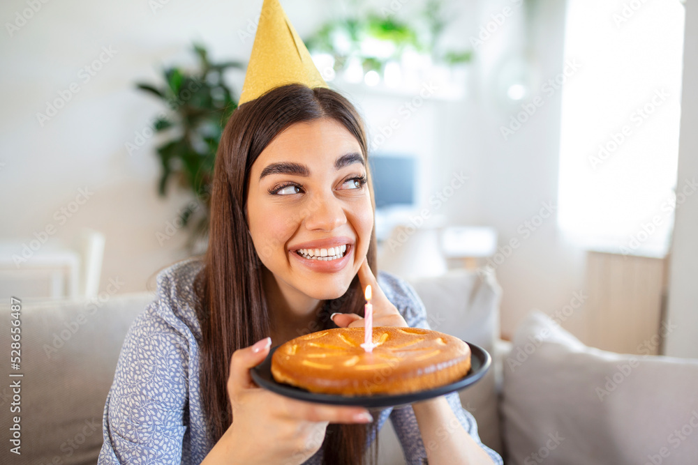 Copy space shot of a cheerful young woman having a birthday celebration event with a friend over a video call. She is making a celebratory toast with a glass of white wine towards laptop camera. Copy space shot of a cheerful young woman having a birthday celebration event with a friend over a video call. She is making a celebratory toast with a glass of white wine towards laptop camera.