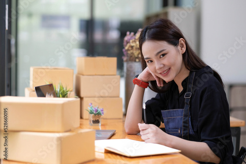 Portrait of Starting small businesses SME owners female entrepreneurs working on receipt box and check online orders to prepare to pack the boxes, sell to customers, sme business ideas online.