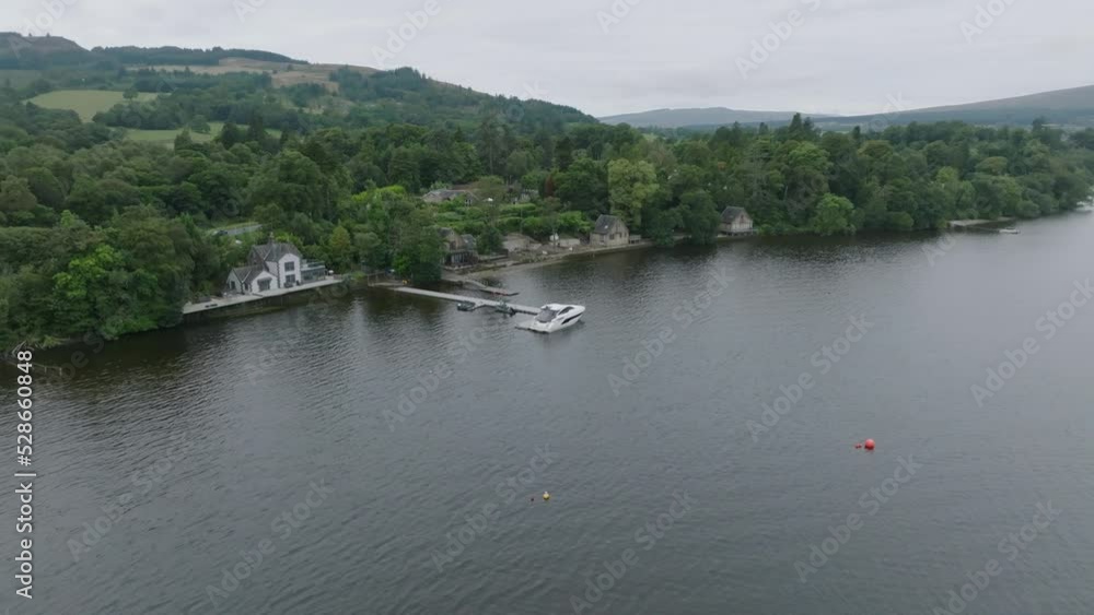 Closing Shot with Tilt Up Of A Docked Boat On The Shores Of Loch Lomond. Closing Shot with Tilt Up Of A Docked Boat On The Shores Of Loch Lomond.
