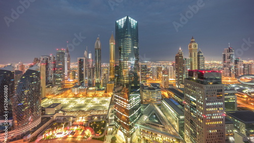 Panorama of futuristic skyscrapers in financial district business center in Dubai night to day timelapse