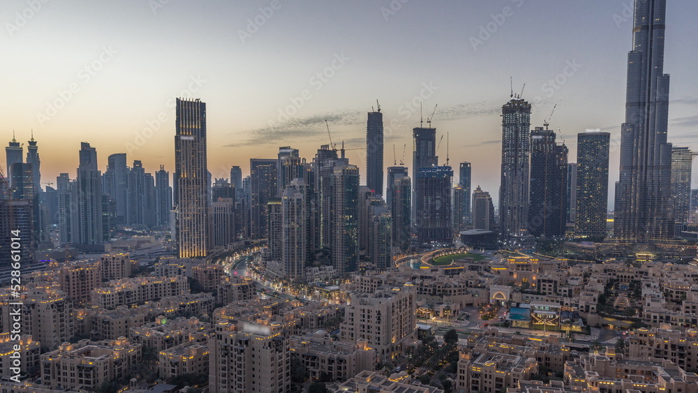 Dubai's business bay towers aerial day to night timelapse. Rooftop view of some skyscrapers