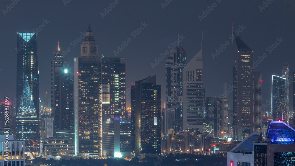 Rows of skyscrapers in financial district of Dubai aerial all night timelapse.