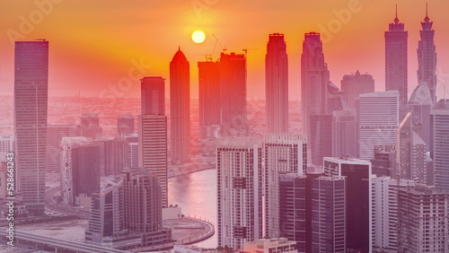 Skyline with modern architecture of Dubai business bay towers at sunset timelapse. Aerial view © neiezhmakov